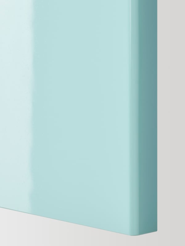 The accent door of a JÄRSTA kitchen front in light turquoise.