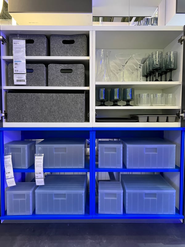 A combination of PLATSA and BESTA cabinets with plastic containers and glasses.