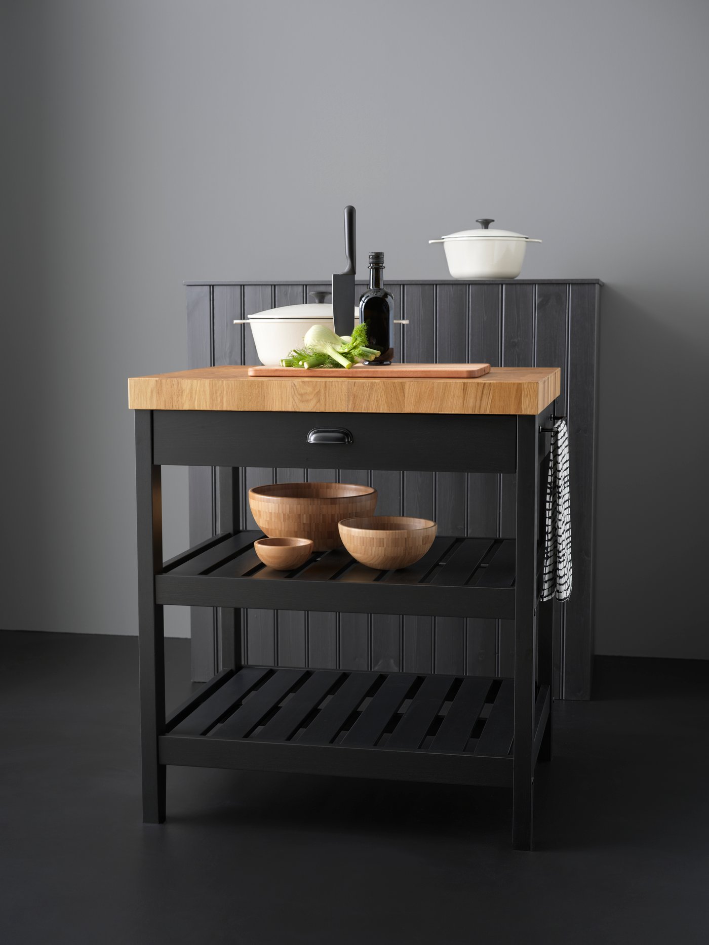 A black/oak VADHOLMA kitchen island in the kitchen