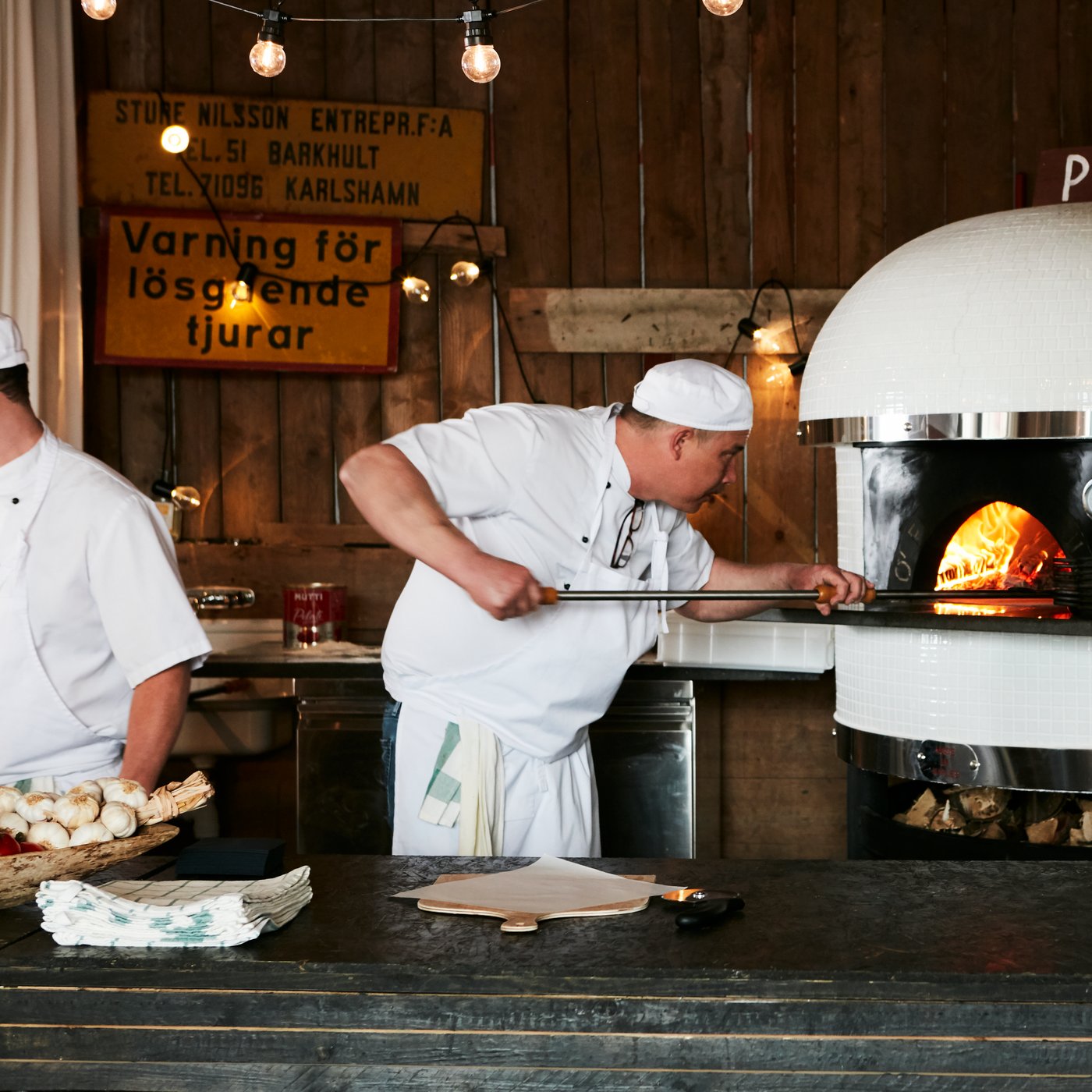 Two chefs in white hats working in the kitchen