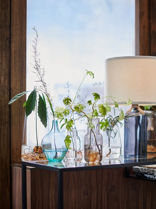 SALONG, FÖRENLIG and BERÄKNA glass vases and TONVIS lamp create a spring still life on a windowsill and VITTSJÖ table.