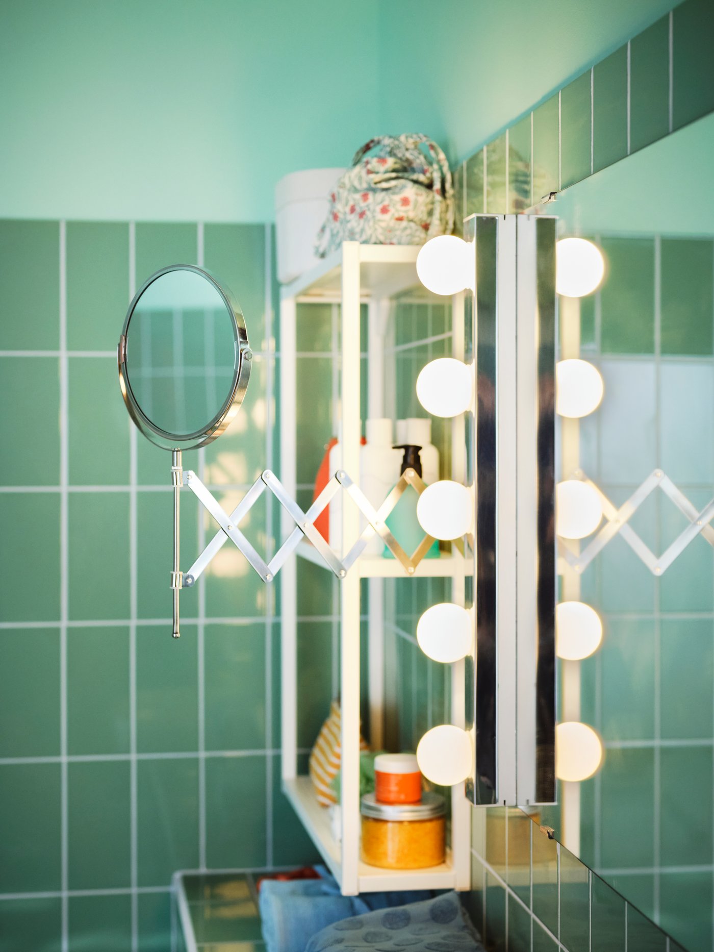 Ein ausziehbarer Kosmetikspiegel aus unserer FRÄCK Serie in einem Bad in frischem Grün.