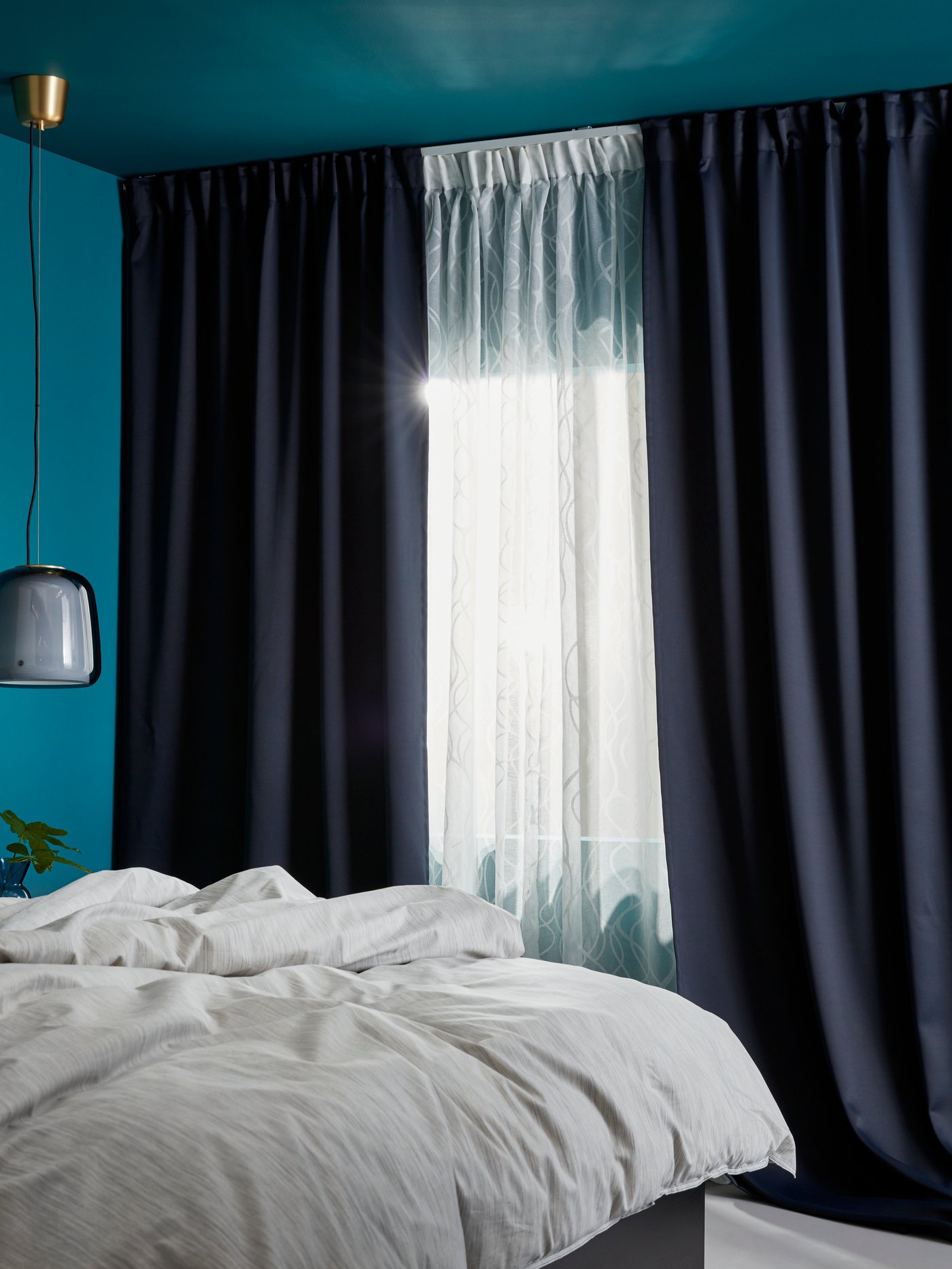 A dark blue MAJGULL block-out curtains, 1 pair in the bedroom