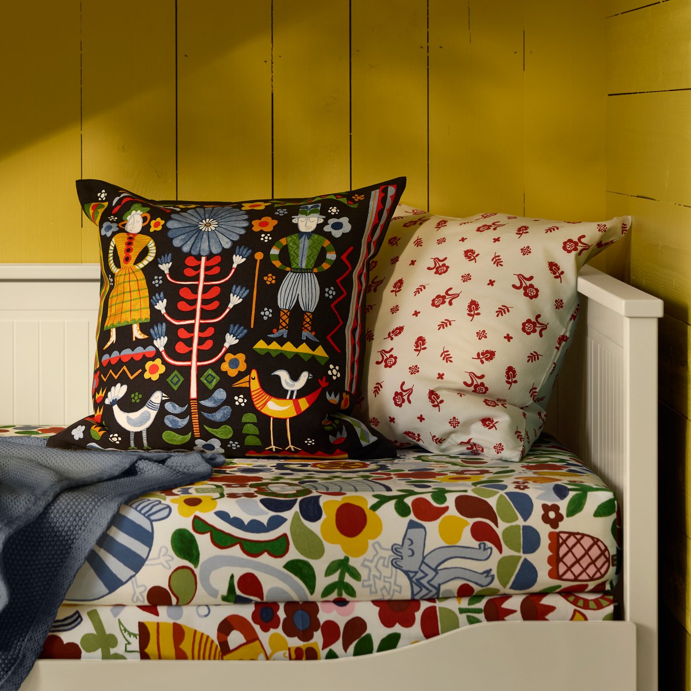 A multicolour TRATTKAKTUS cushion cover in the bedroom