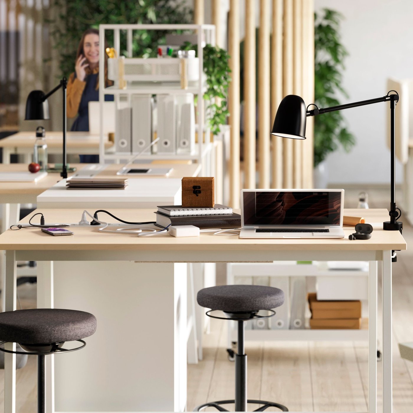 An airy office space with MITTZON high conference tables, three black LIDKULLEN sit/stand support and a large whiteboard.