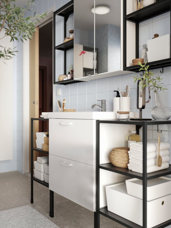 A bathroom wall featuring an ENHET base cabinet for wash-basin with 2 drawers, open frames with shelves and two mirror doors.
