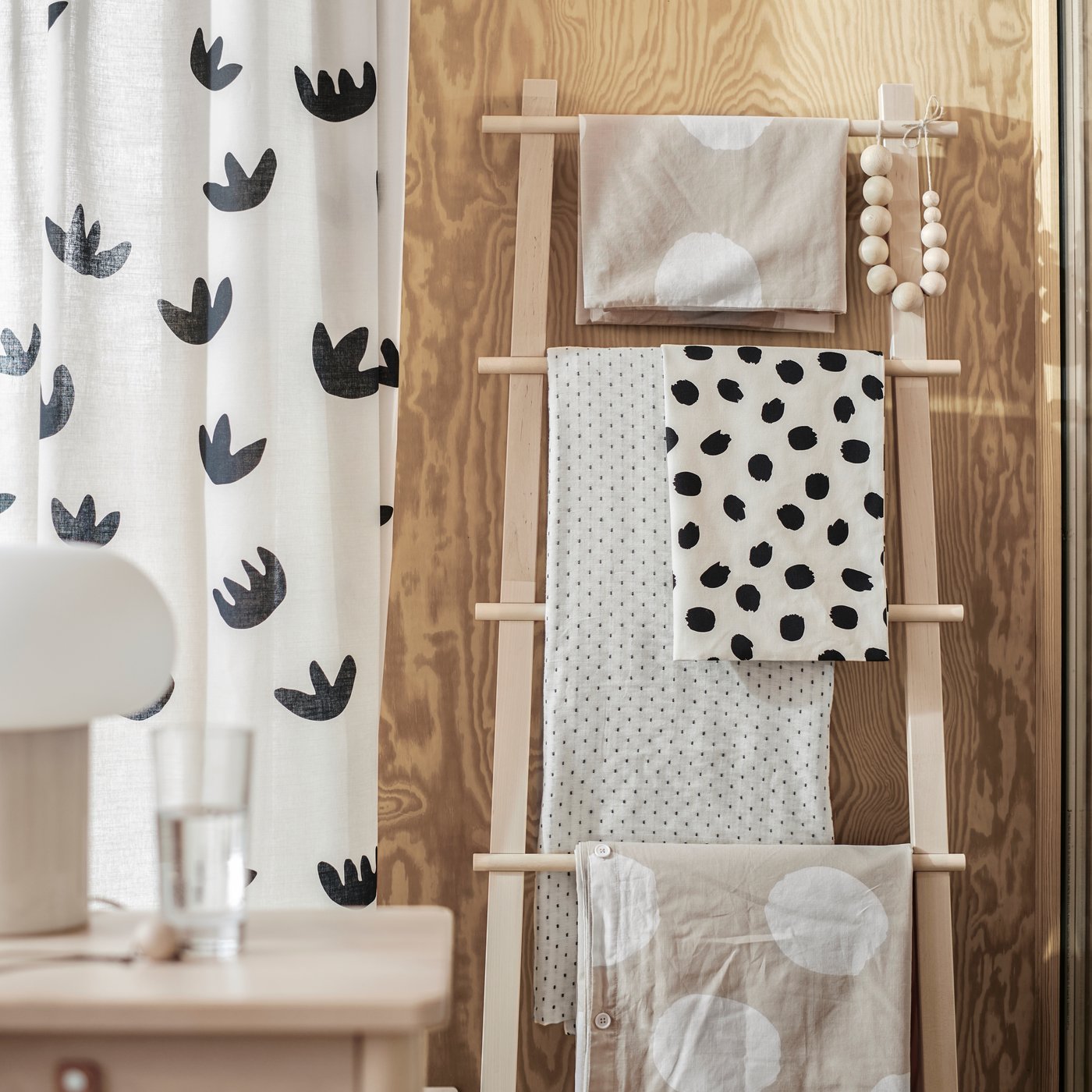 A beige/black NÄCKROSMOTT curtains, 1 pair