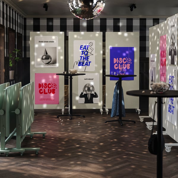 An office break room with a disco ball, where MITTZON frames create a closed-off space with foldable tables on the side.