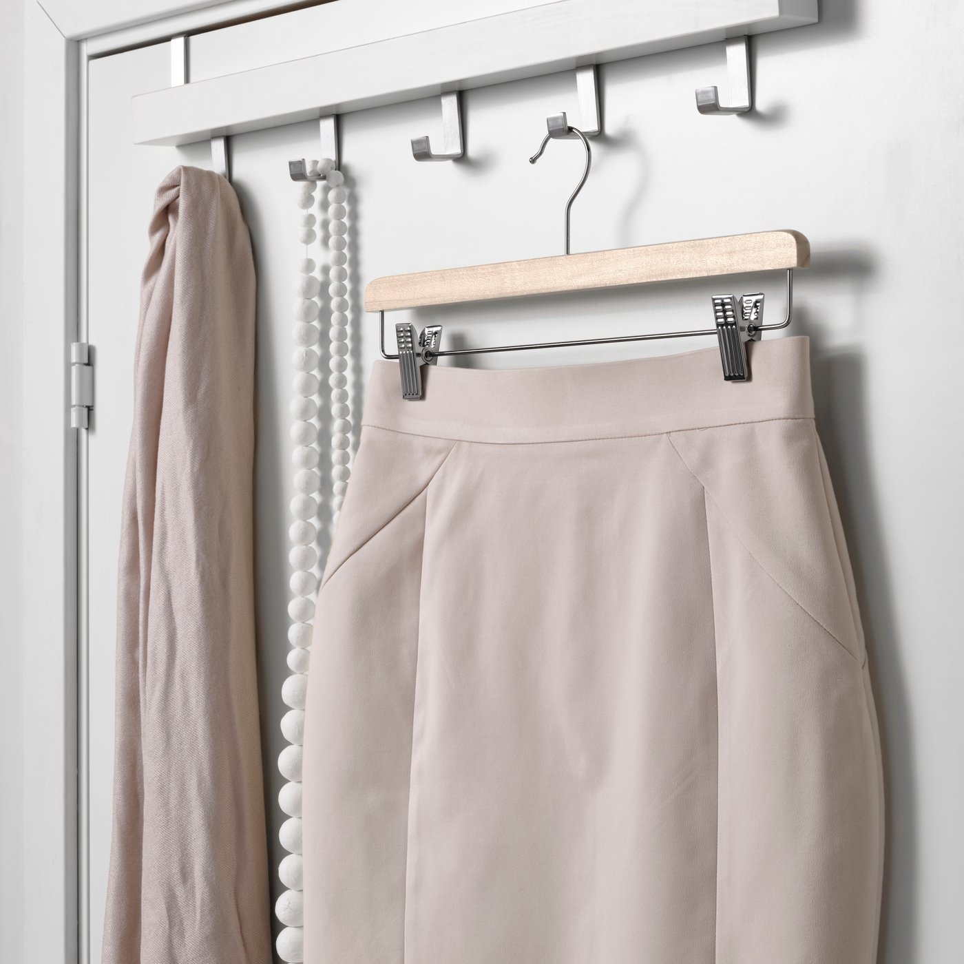 A natural BUMERANG skirt hanger