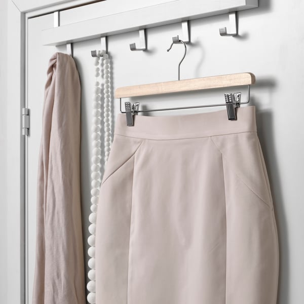 A natural BUMERANG skirt hanger