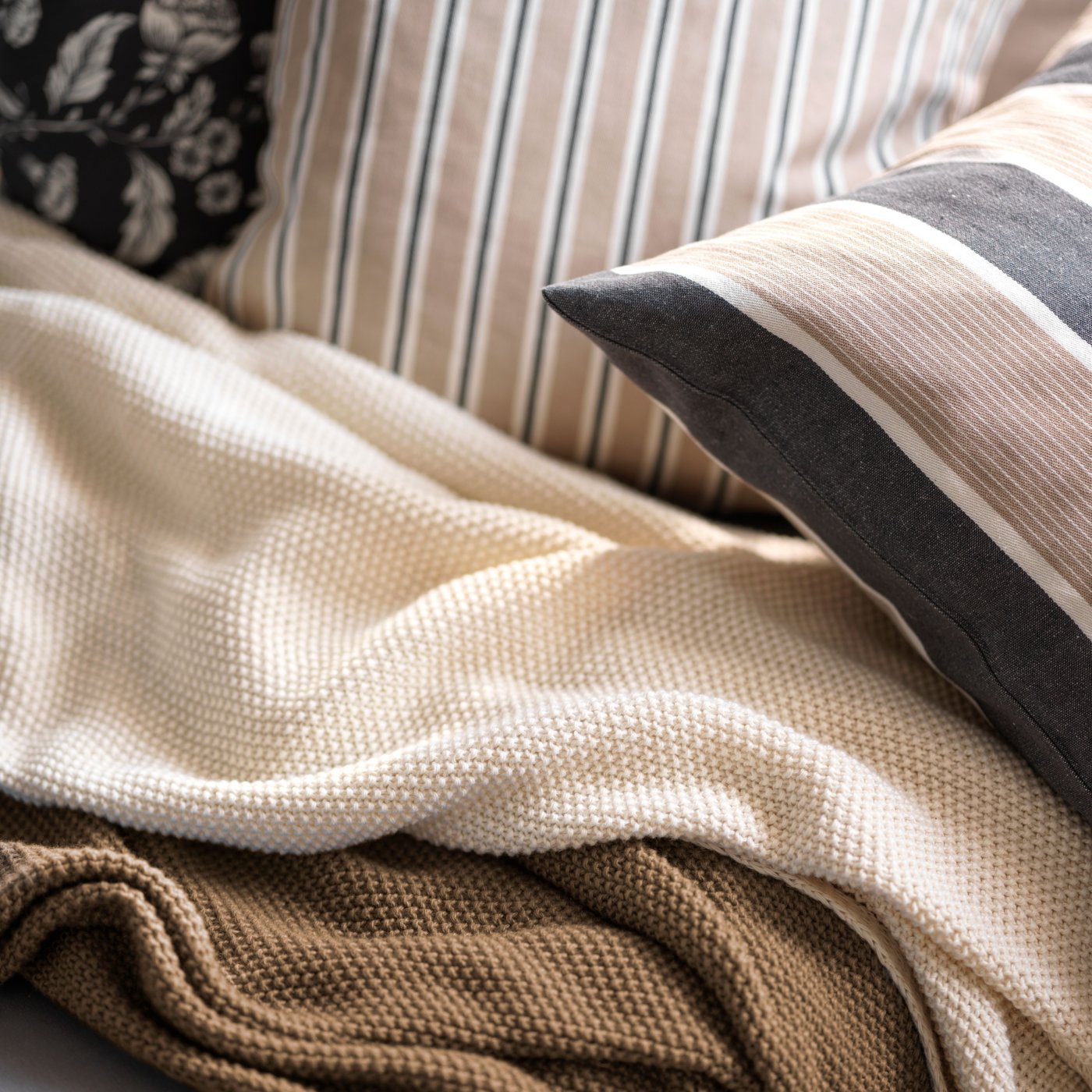 A beige white/stripe pattern KORALLBUSKE cushion cover