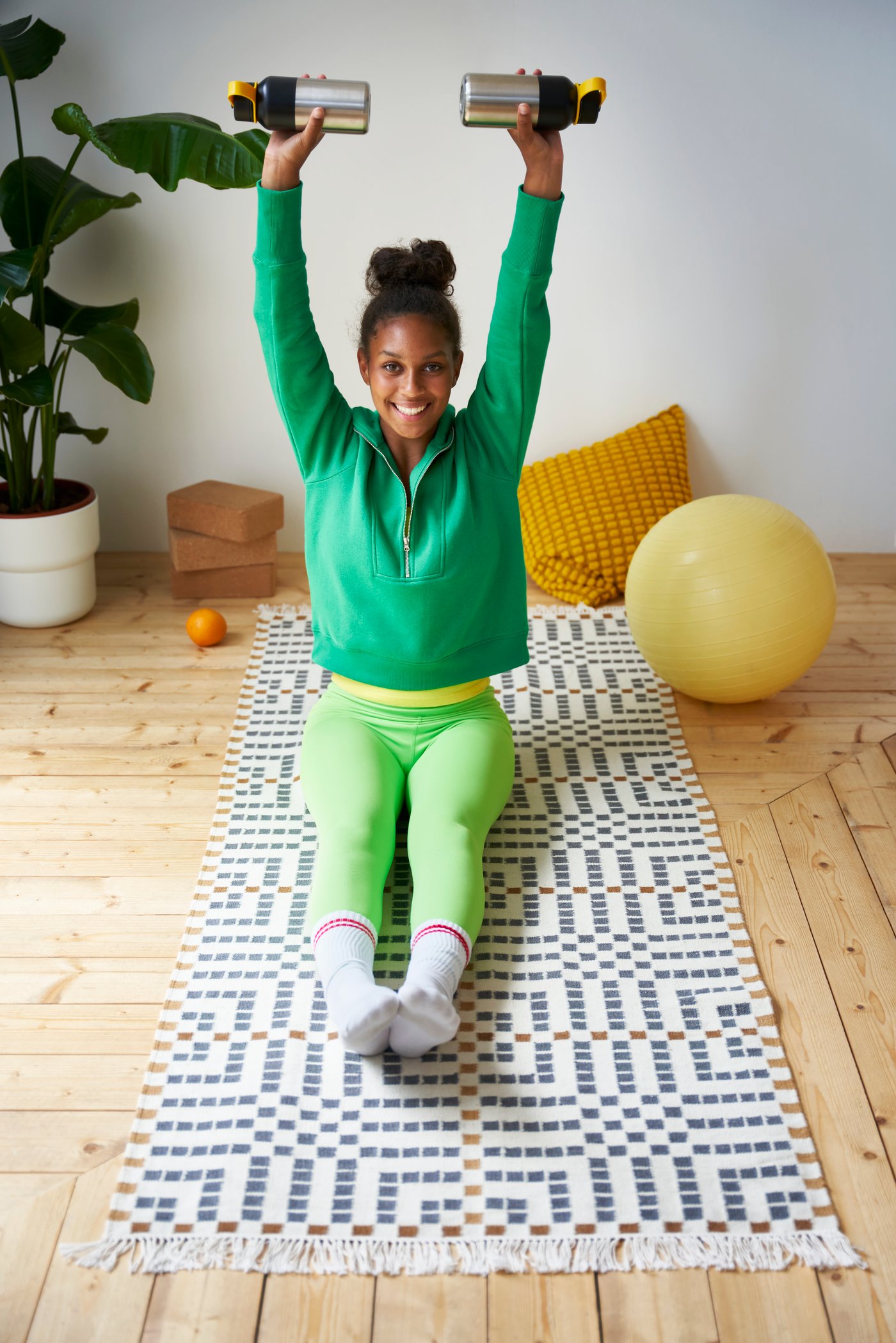 Kobieta ćwicząca na długim dywanie w pokoju dziennym.