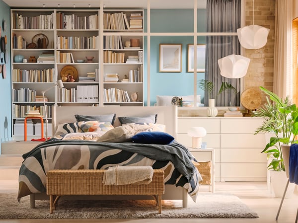 Two white BÄCKNATE pendant lampshades hang above white MALM chests of 4 drawers near a bedroom window.