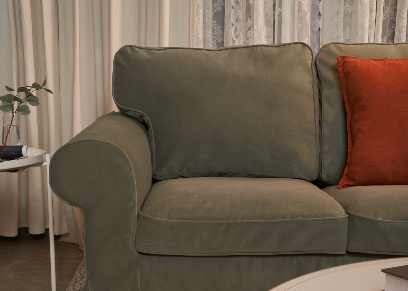 A Hakebo grey-green EKTORP 3-seat sofa in the living room