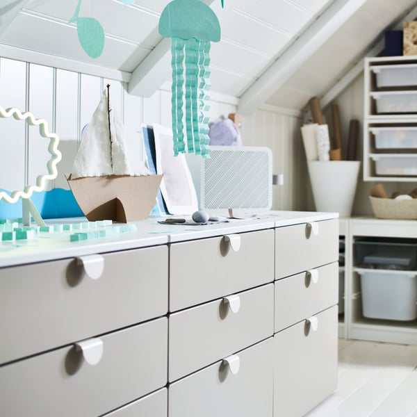 Three SMÅSTAD/PLATSA chests of 3 drawers stand in a row with various items on top of them, including an air purifier.