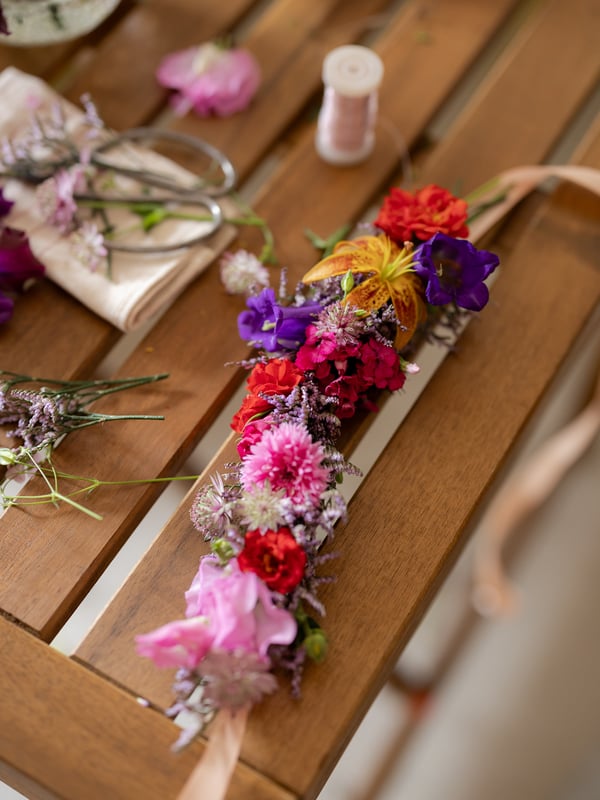 Handmade wreath with wildflowers on IKEA TÄRNÖ garden table for Midsommar