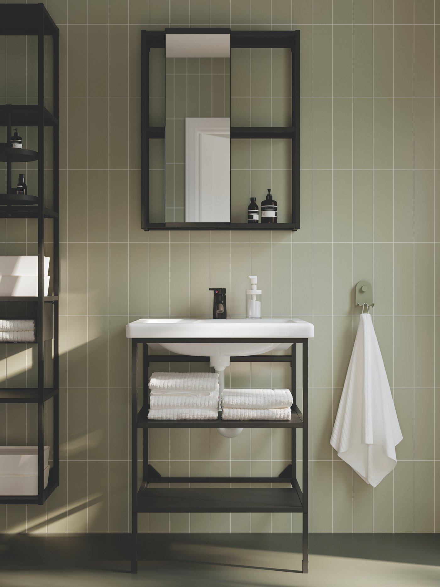 A bathroom has an ENHET open wash-stand with two shelves and legs in anthracite and a TVÄLLEN single wash-basin.