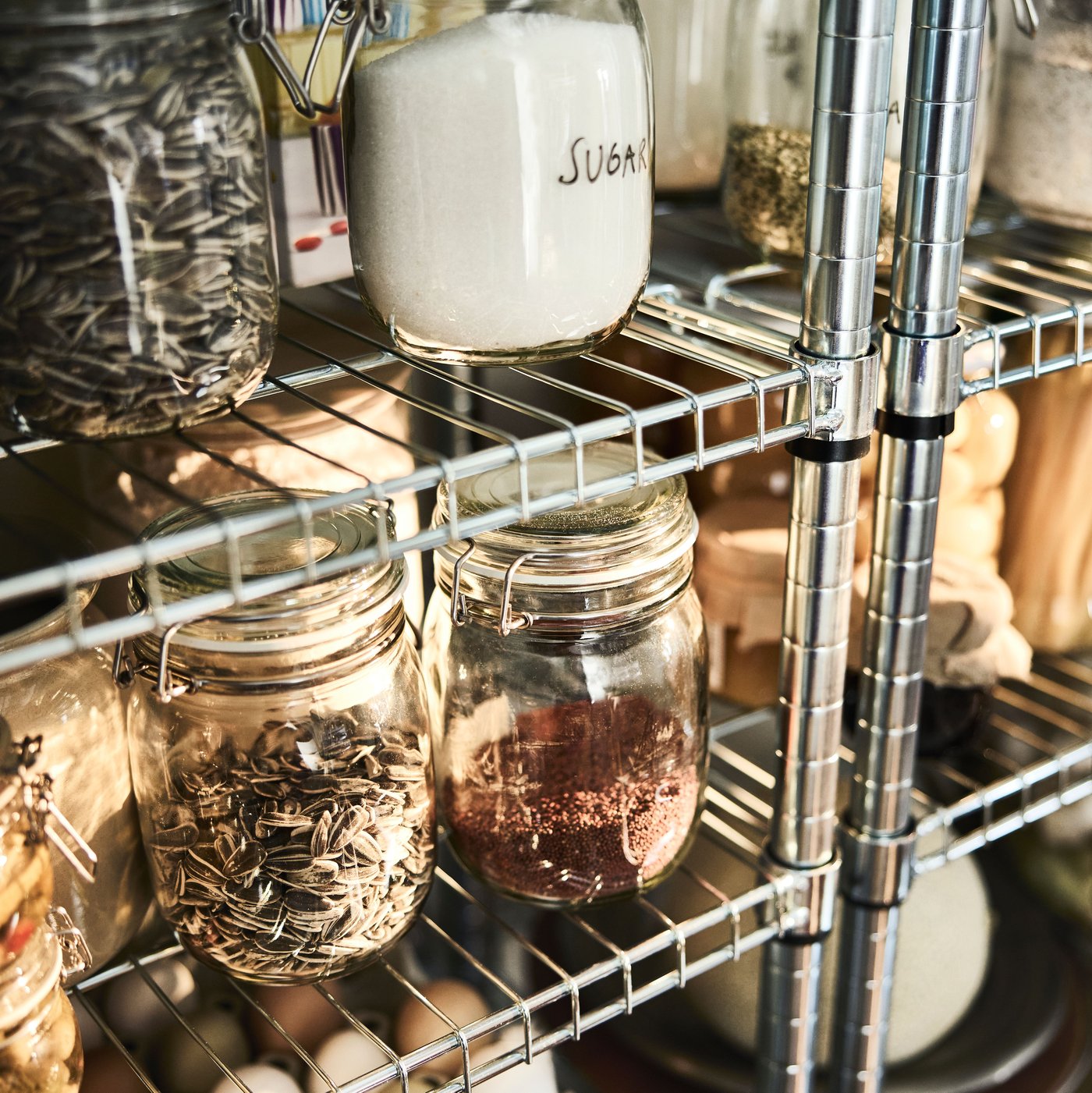 OMAR shelving units store and organise dry food for an open pantry.