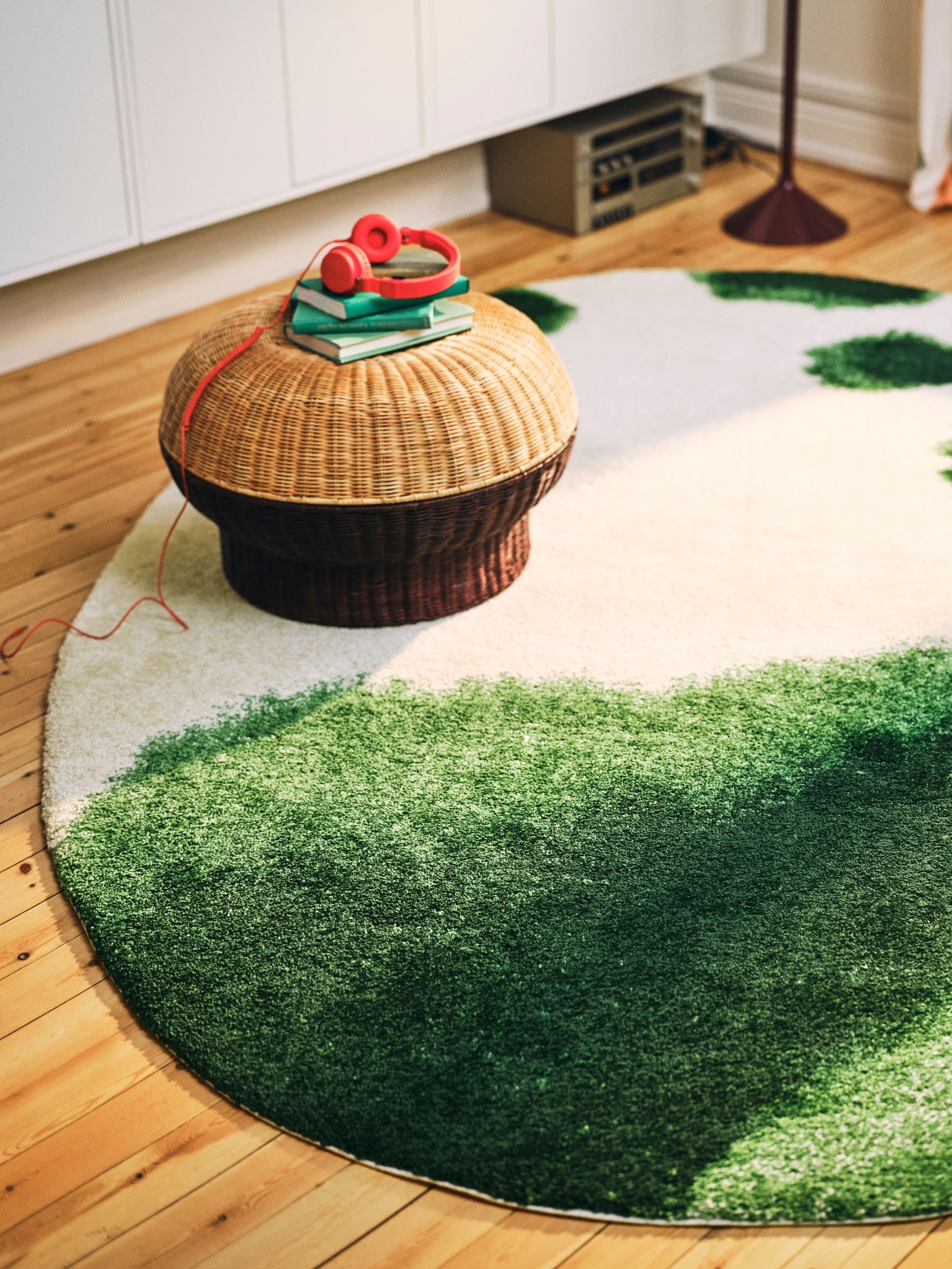 An oval/green off-white IKEA PS 2026 rug, low pile