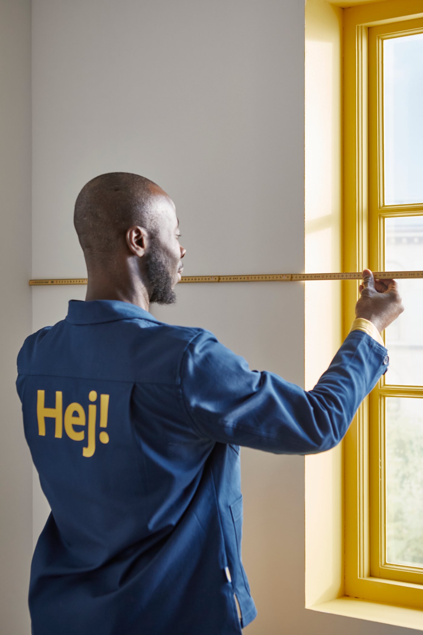 IKEA coworker measuring wall