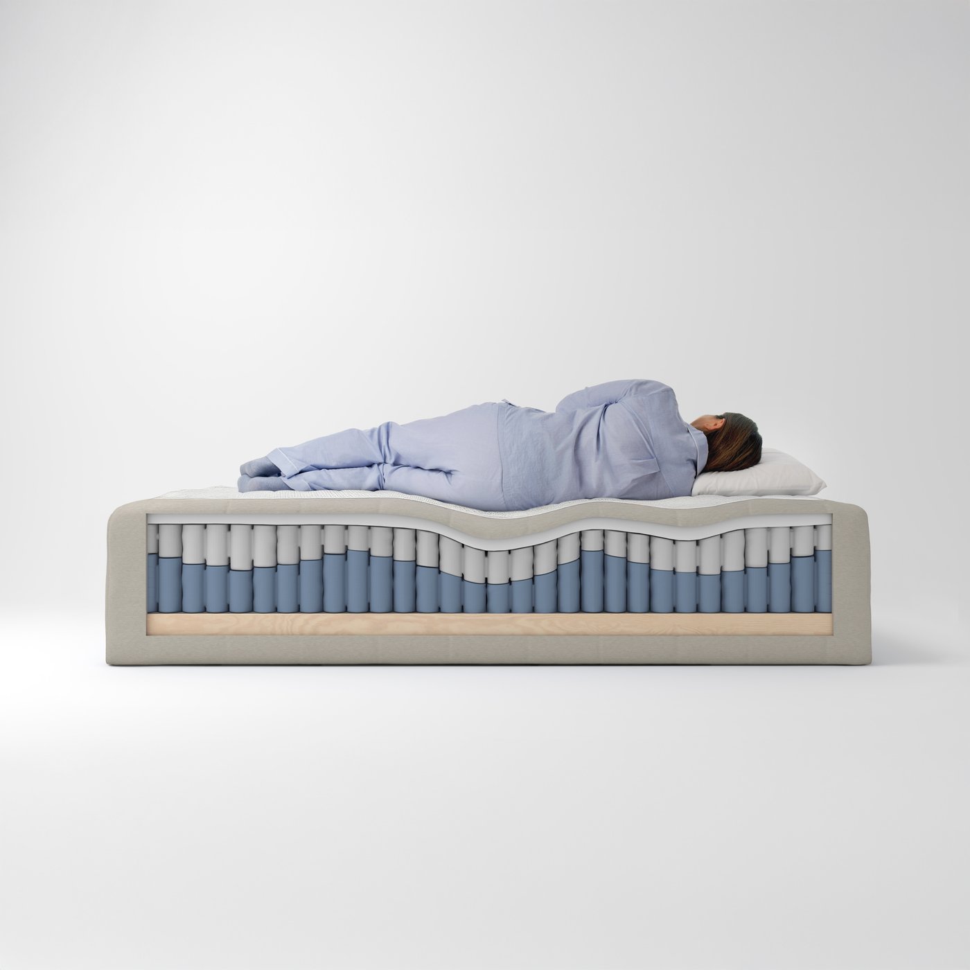 A person lies sleeping on a FJÄLLÅSEN pocket spring core which has had part of its wooden base cut away on one side.