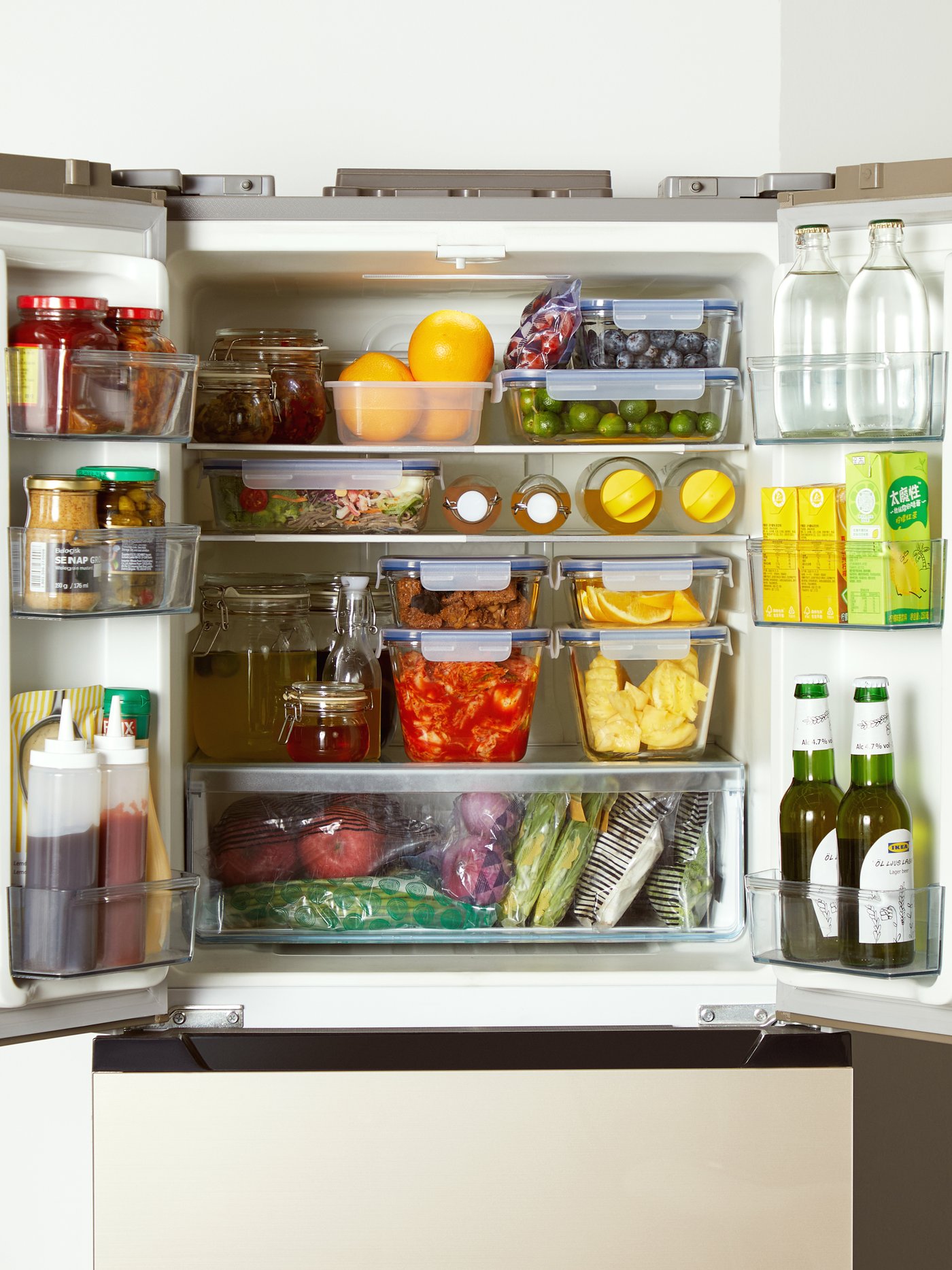 Neatly stacked food containers in a fridge