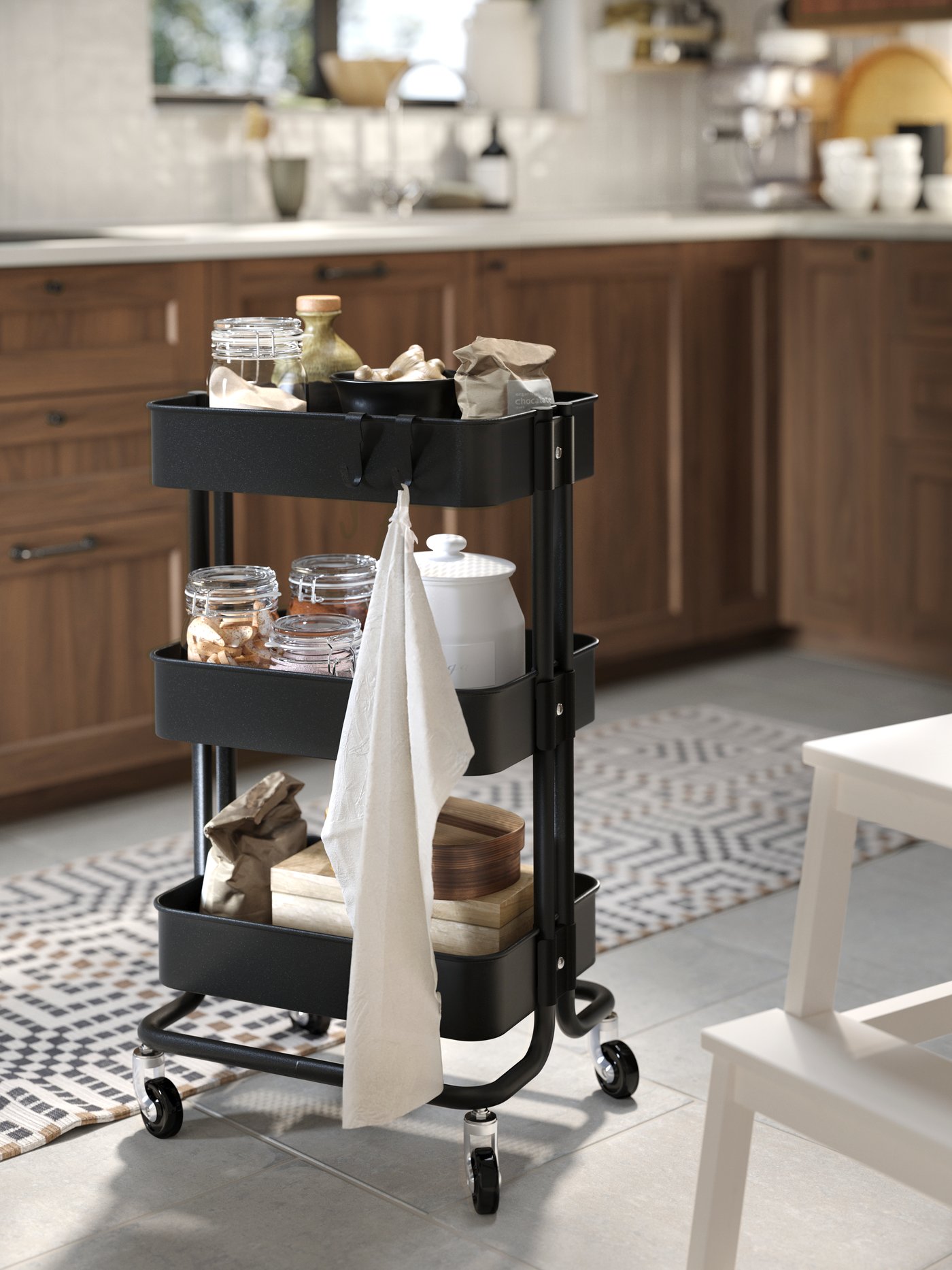 A black RÅSKOG trolley in the kitchen