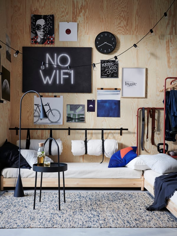 A black DELAKTIG LED floor lamp in the bedroom