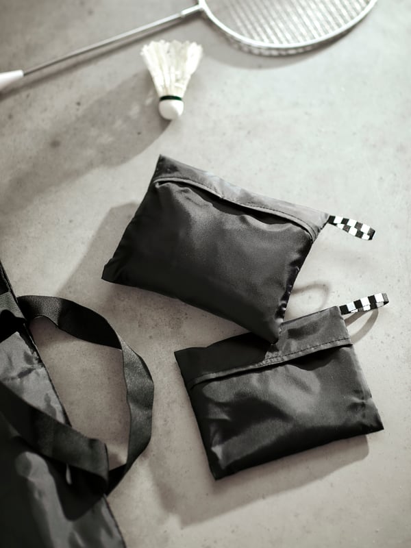 Close-up of RÄCKLA bags in both sizes, packed into smaller carry bags for added convenience.