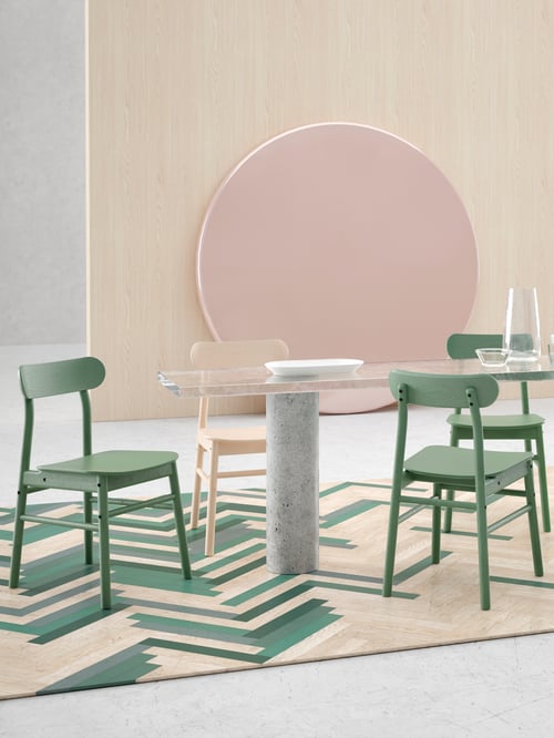 Mur indépendant en bouleau près d’une table de salle à manger en verre et de trois chaises RÖNNINGE vertes dont les assises sont arrondies et les dossiers inclinés.