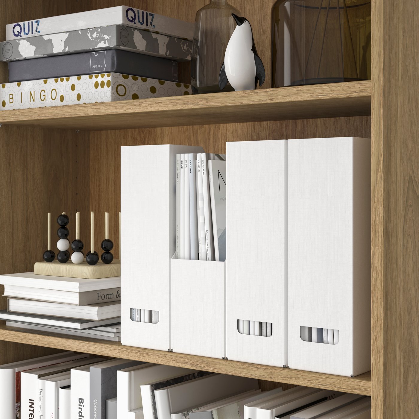 A section of a bookcase neatly arranged with board games, books decoration and several white FJÄDERHARV magazine files.