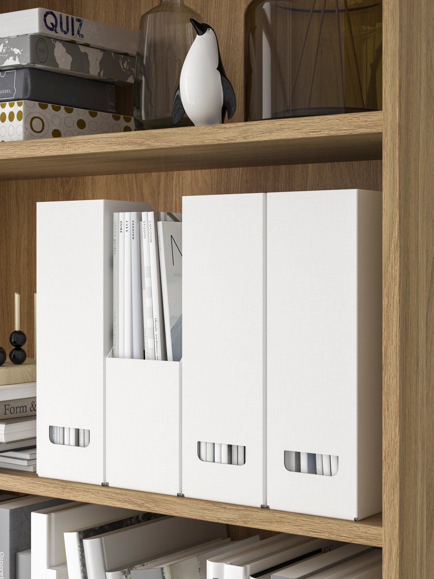 A section of a bookcase neatly arranged with board games, books decoration and several white FJÄDERHARV magazine files.