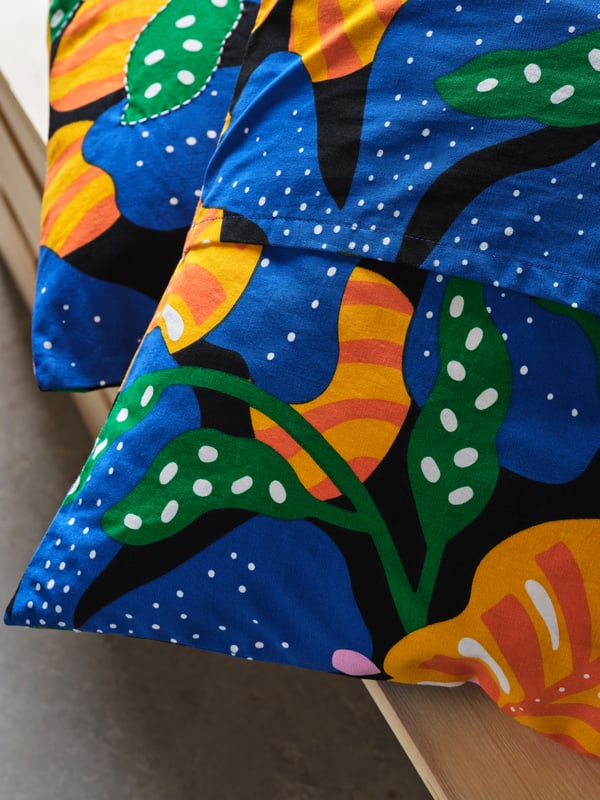 A multicolour/floral pattern MÄVINN cushion cover.