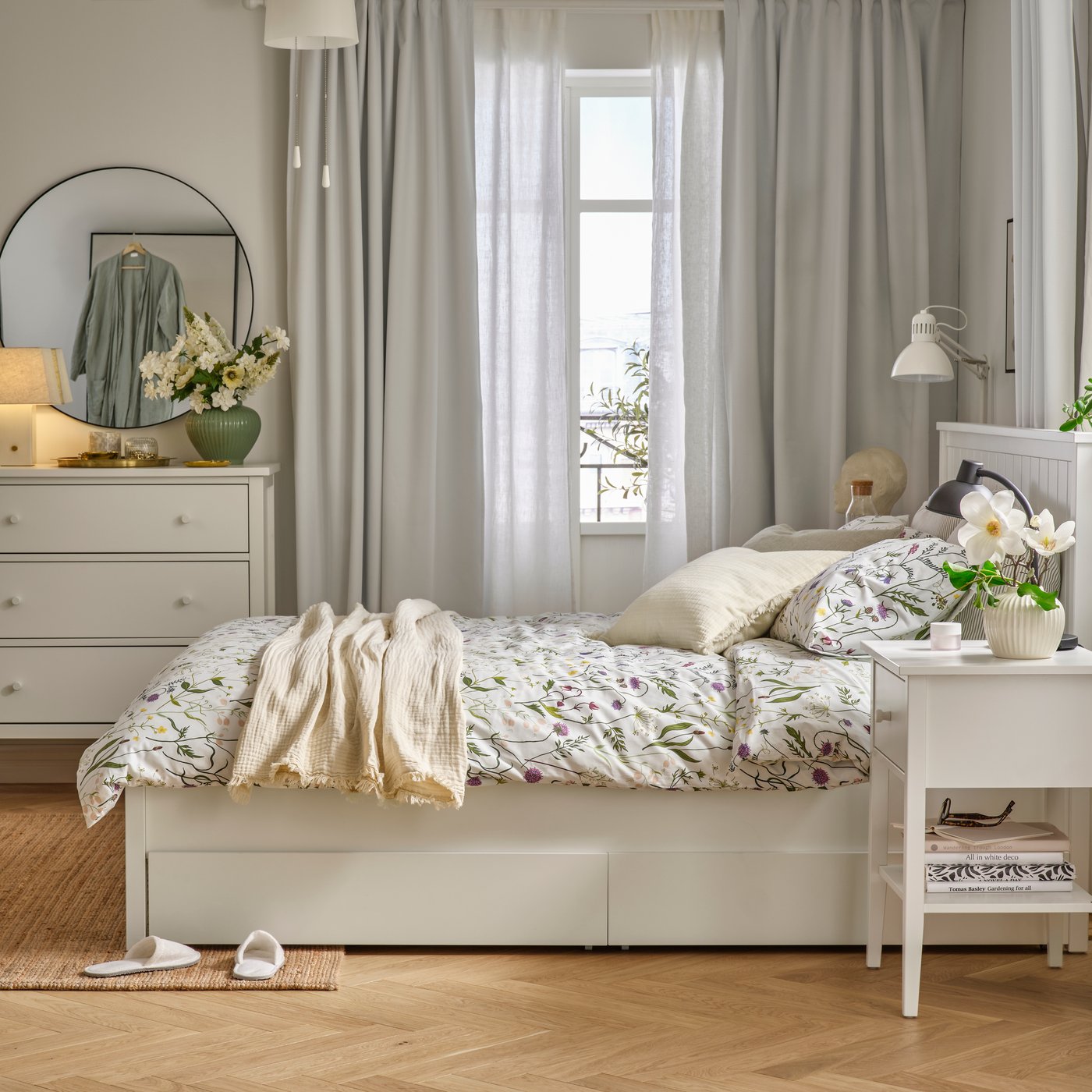A bedroom with pale blue/floral pattern MATTOXBÄR bed linen features floral patterns on a GULLABERG bed frame.