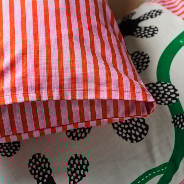 An off-white black/floral pattern MÄVINN cushion cover