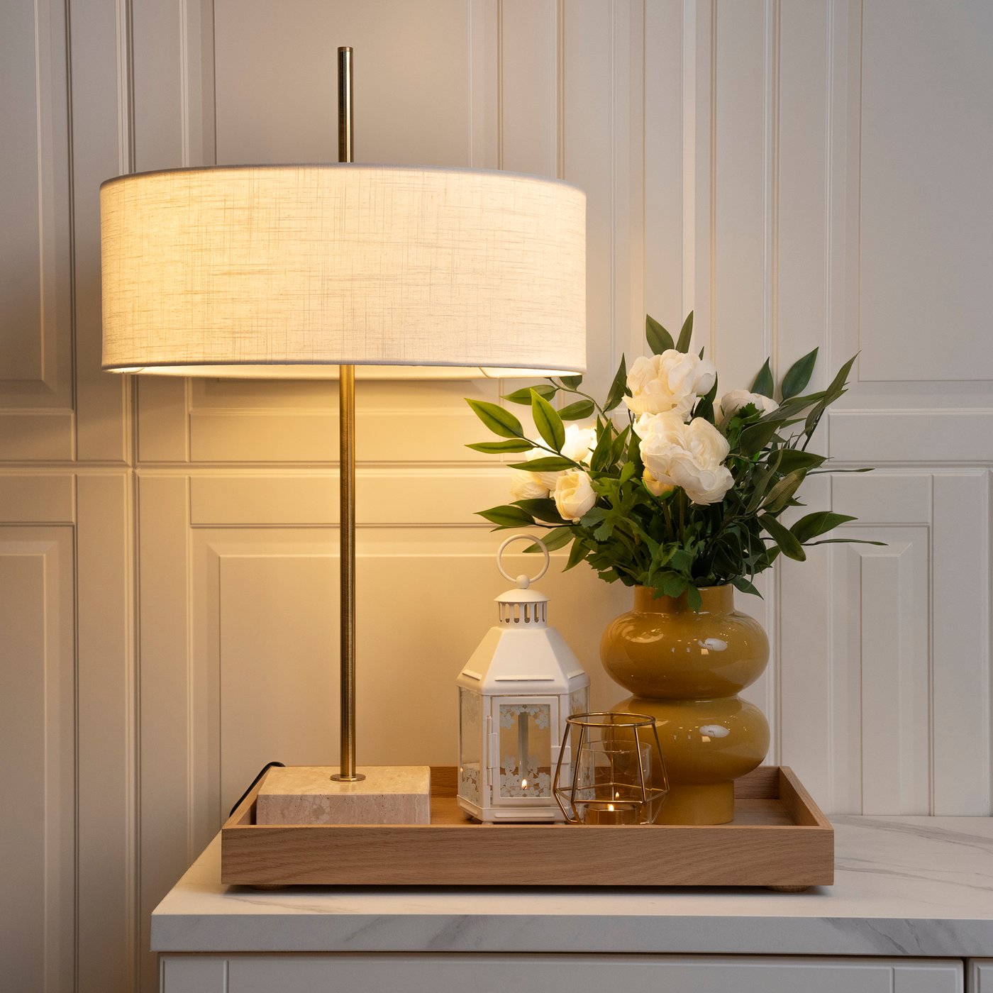 A white textile/brass-plated STOCKHOLM 2025 table lamp