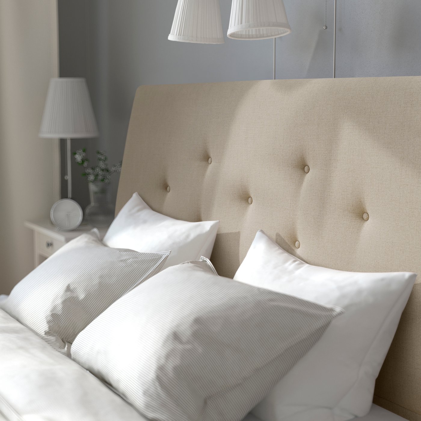 A Naggen beige IDANÄS upholstered bed frame