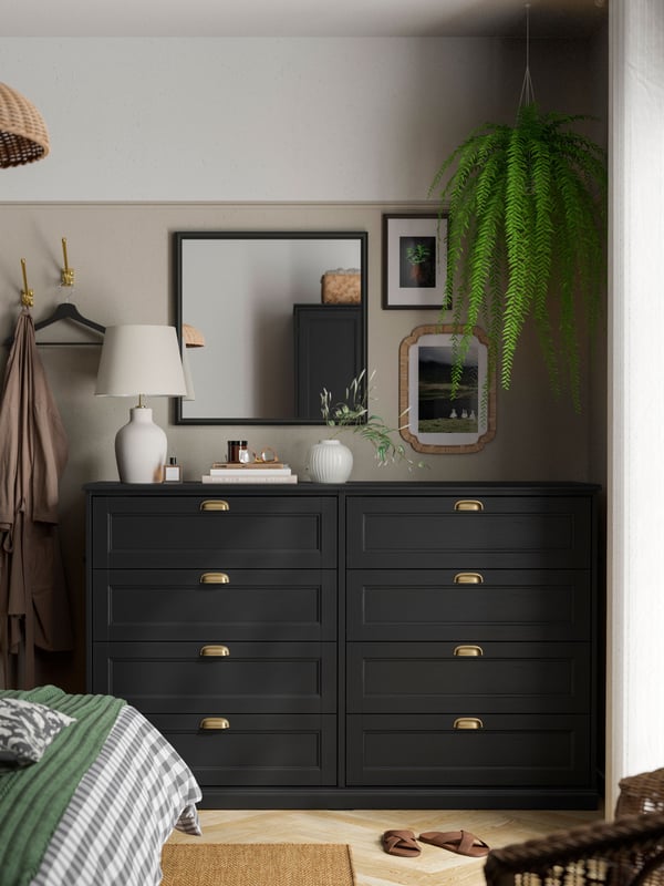 A black oak effect FÅGELFJÄLLET chest of 8 drawers in the bedroom