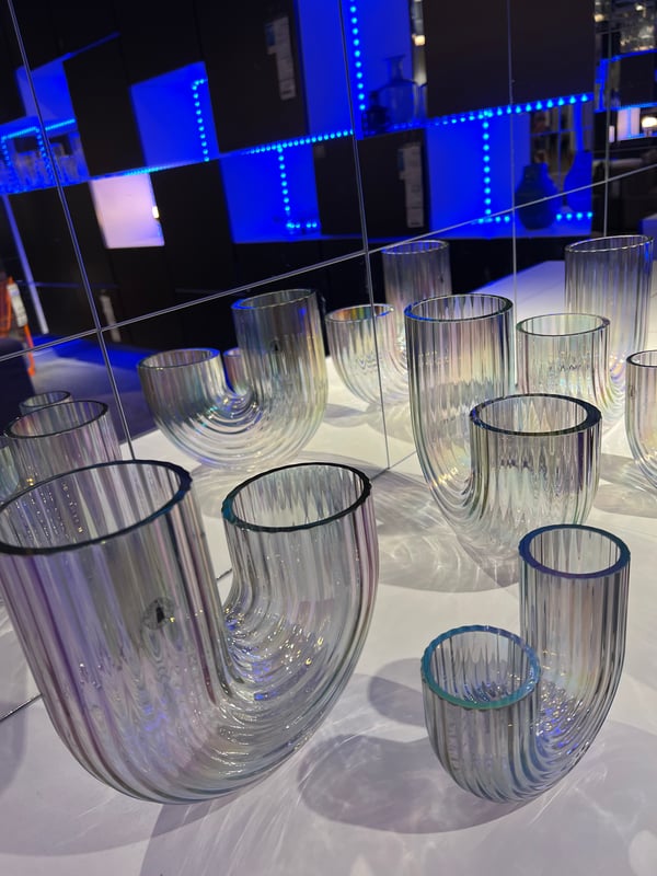 RÄFFELBJÖRK vases in two sizes on a white table with blue LED strips in the background
