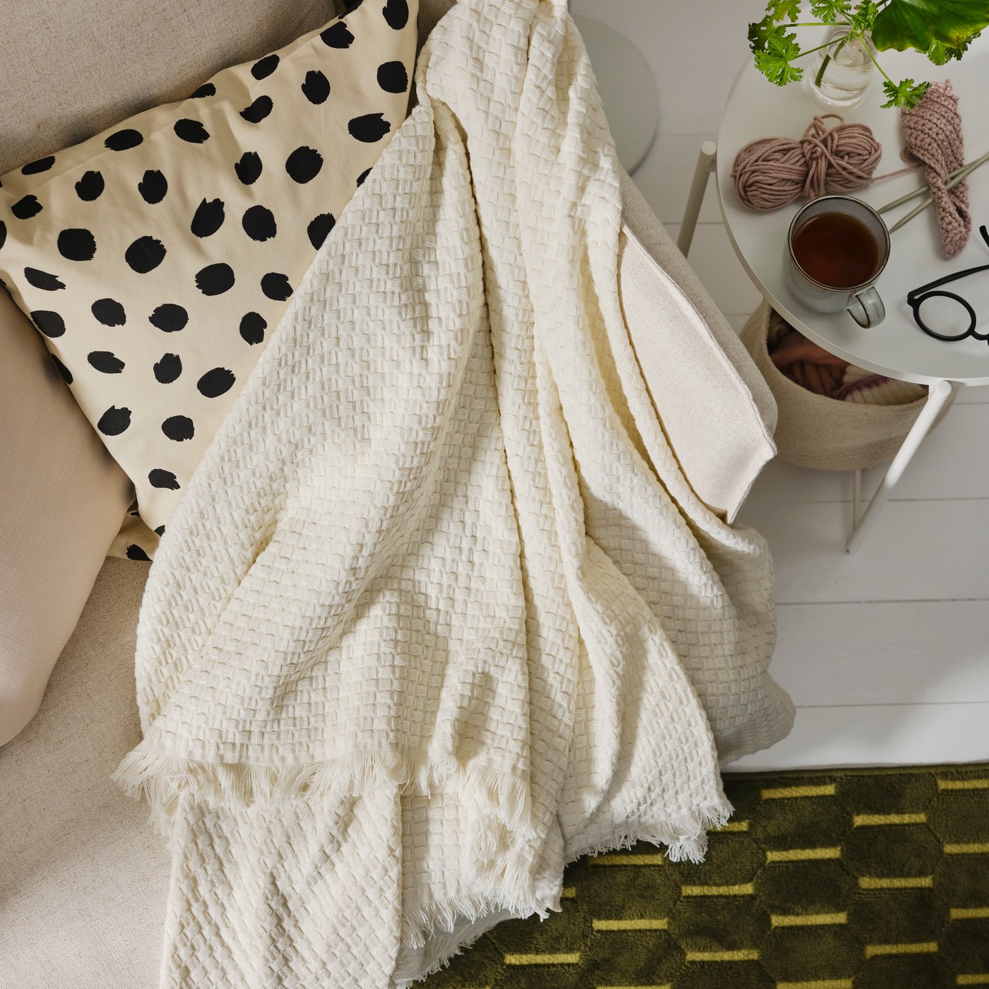 An off-white HORNMAL throw