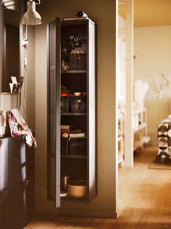 A hallway with a wall-mounted IVAR cabinet containing KUGGIS boxes with lids, and two TRONES shoe cabinets to the side.
