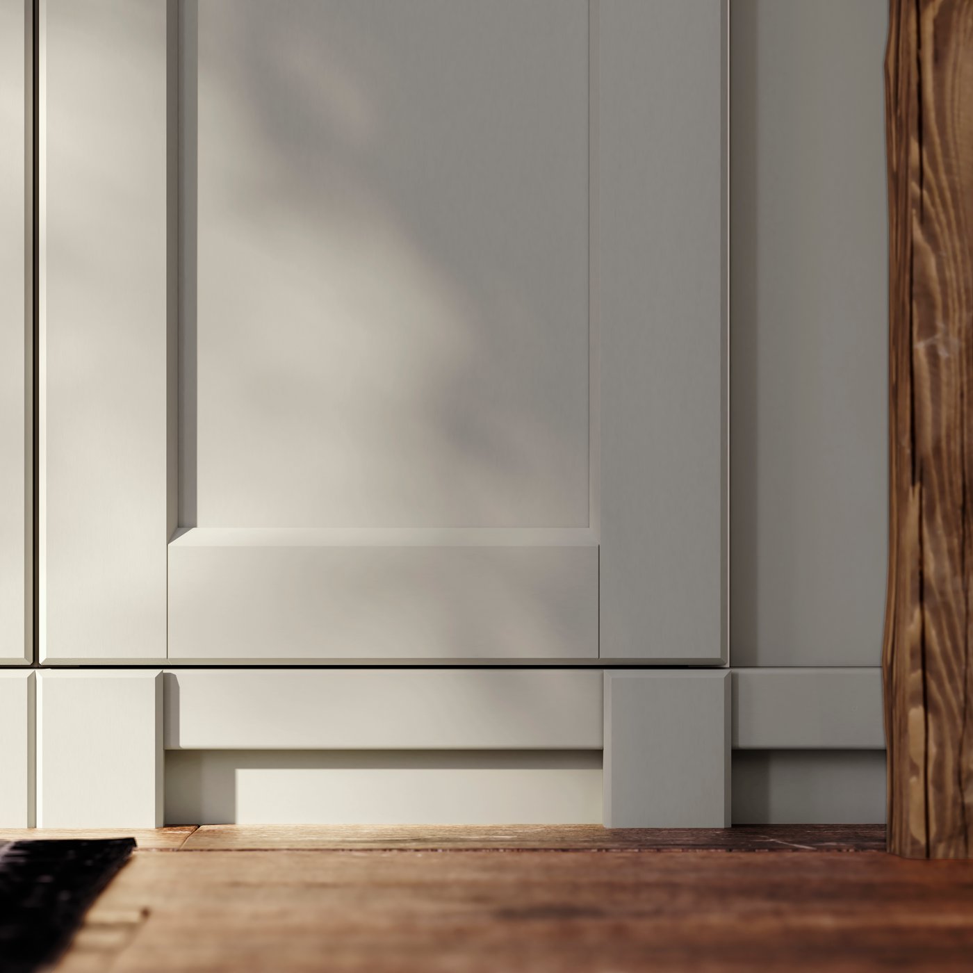 A light grey LERHYTTAN corner leg for decorative plinth in the kitchen