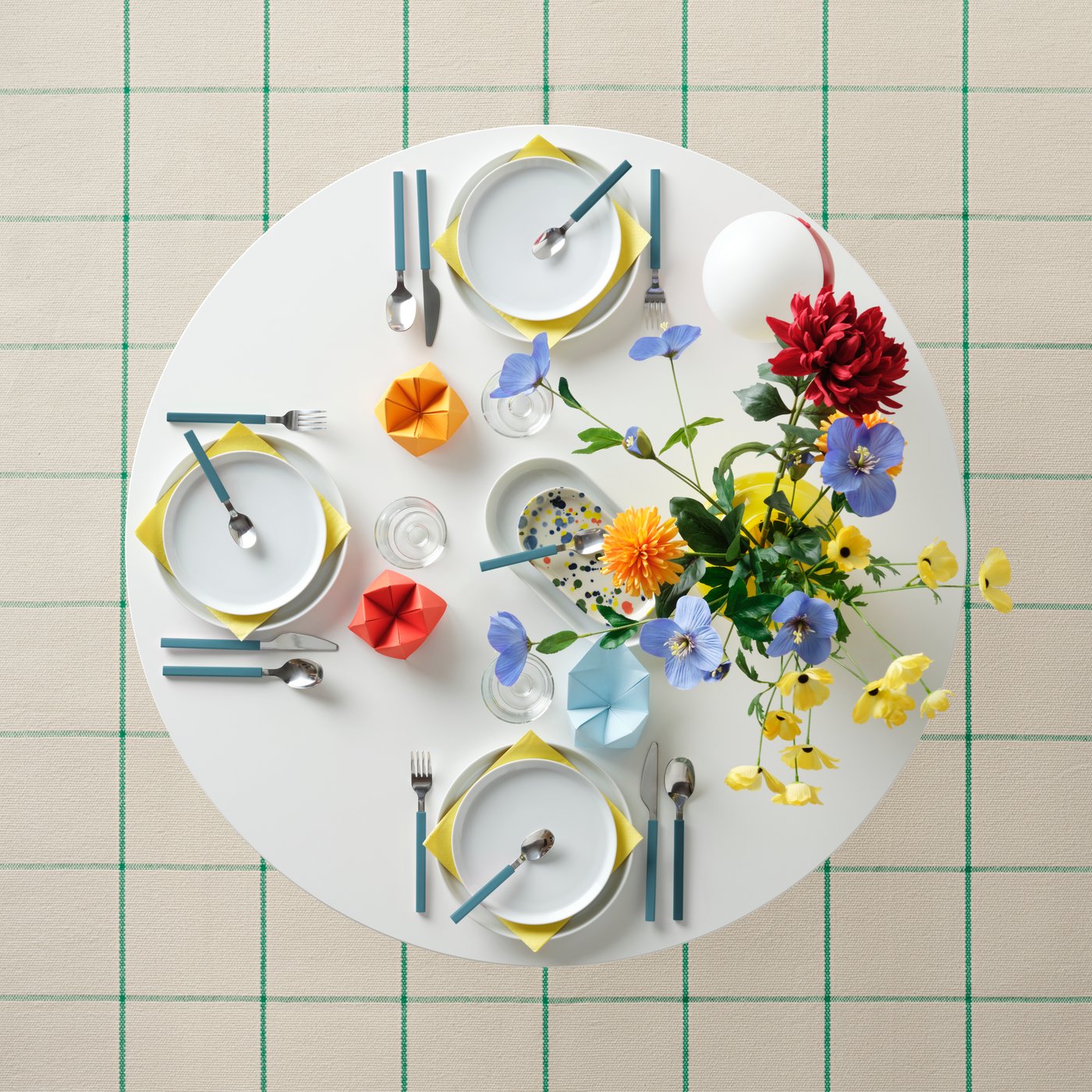 An in/outdoor Ranunculus/yellow SMYCKA artificial flower in the dining room
