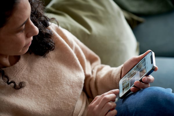 A girl on the sofa looking at her phone 