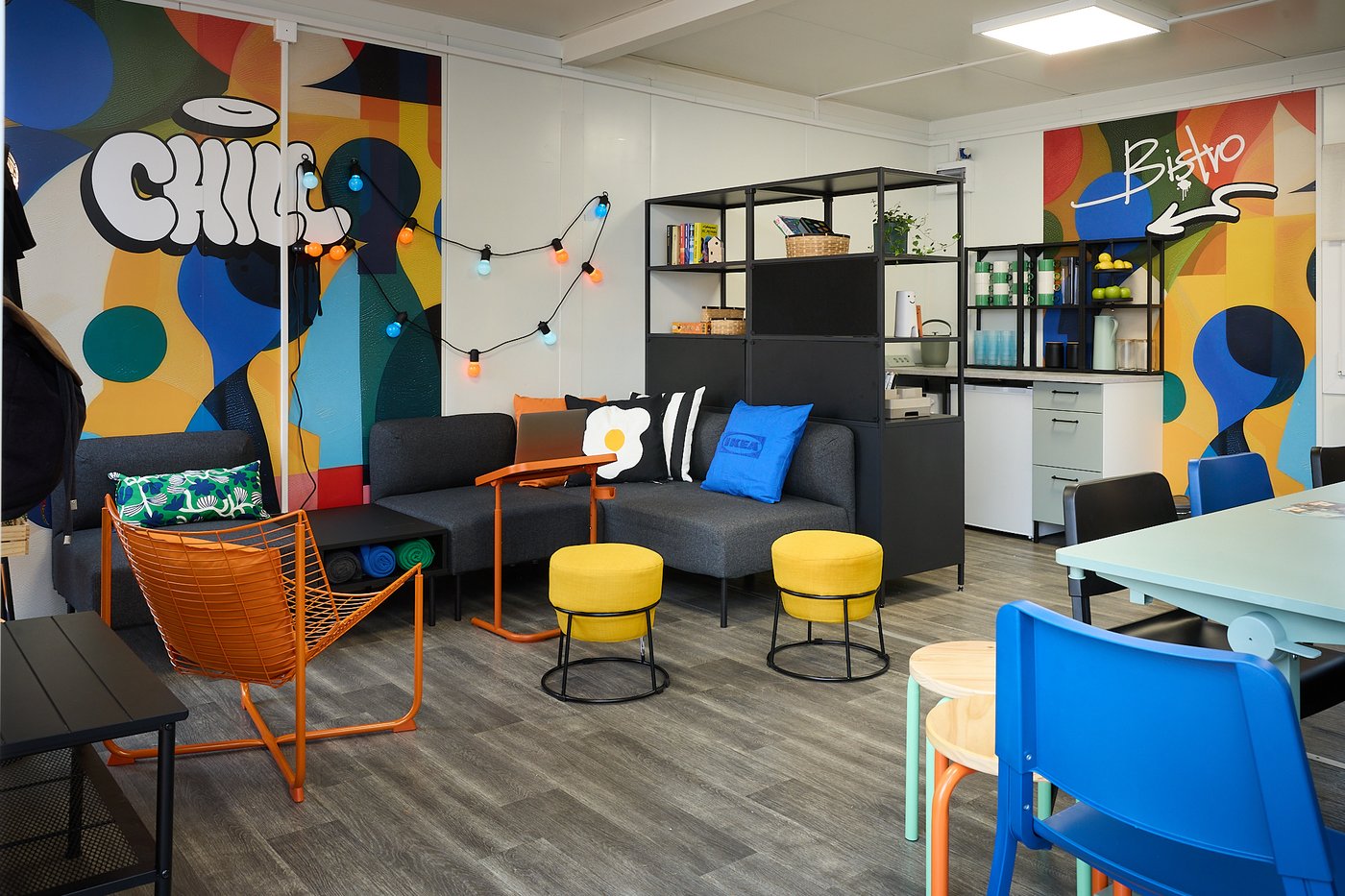 Kolorowa, nowoczesna przestrzeń chillout z kanapą, stolikami i mini bistro