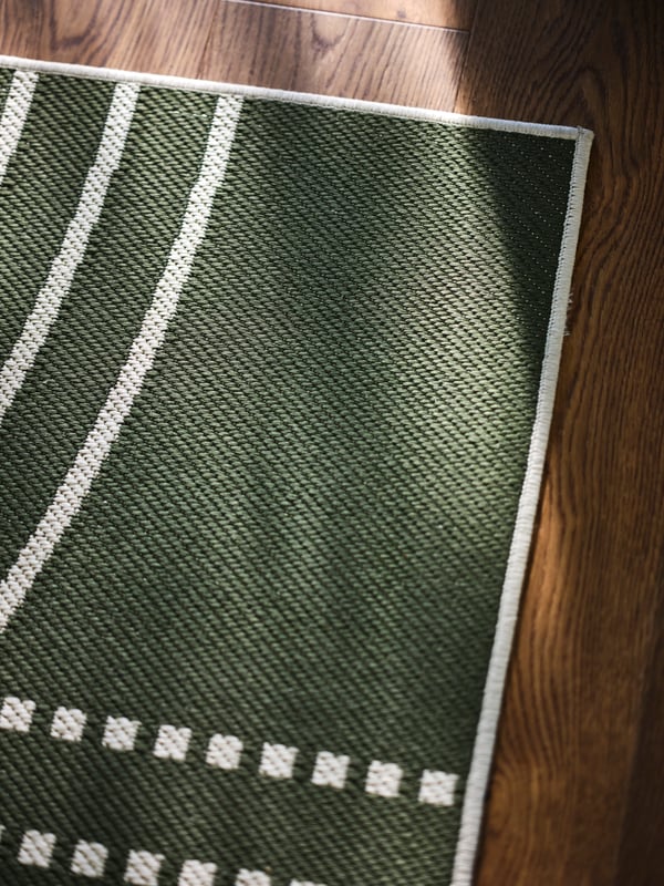 Dark green rug in a room