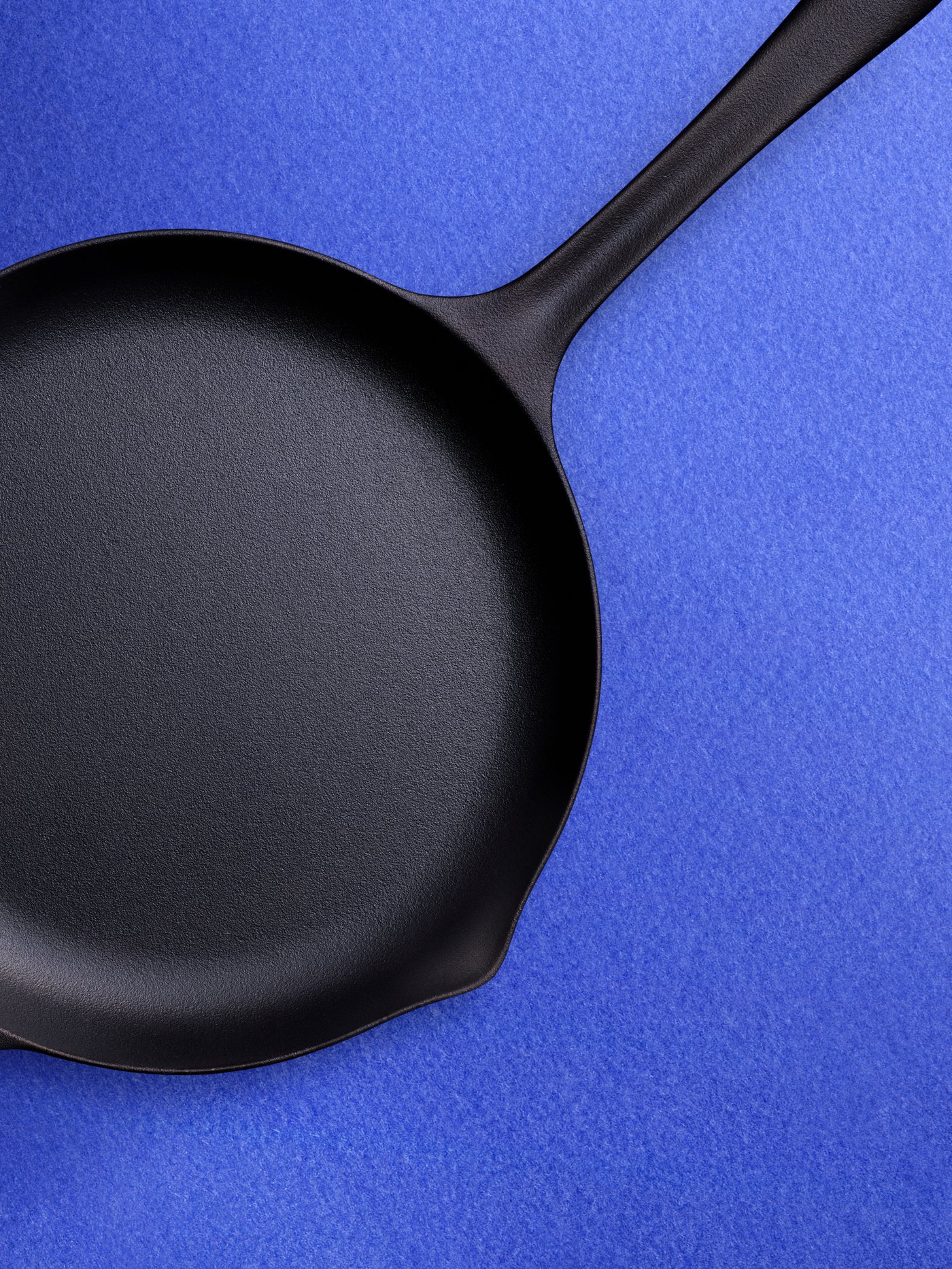 Cast iron pan on a blue background