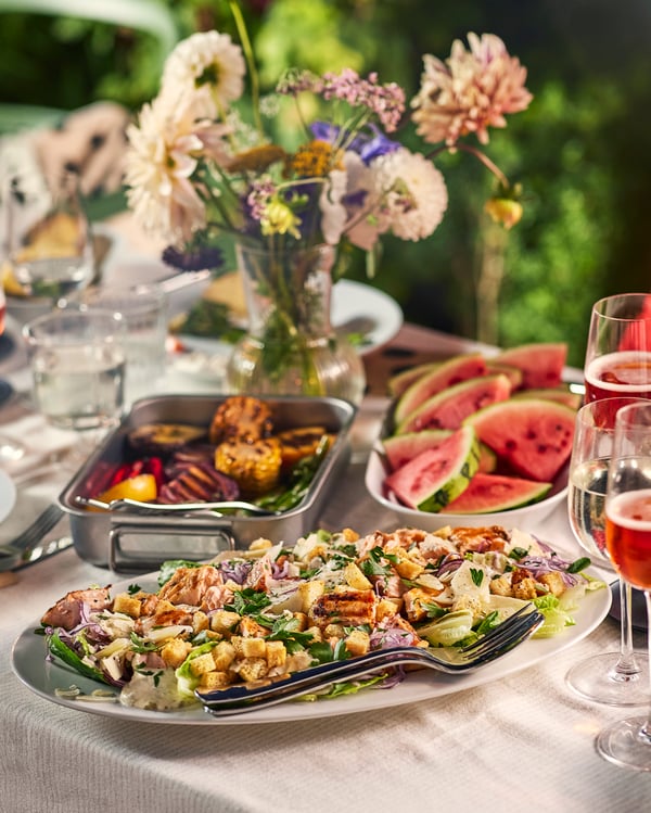 A summery midsummer buffet with grilled meats, watermelon and a summery salad.