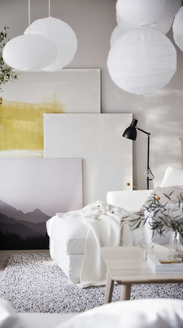 IKEA GRÖNLID soft white cotton chaise longue in a living room setting with hanging white lamps.