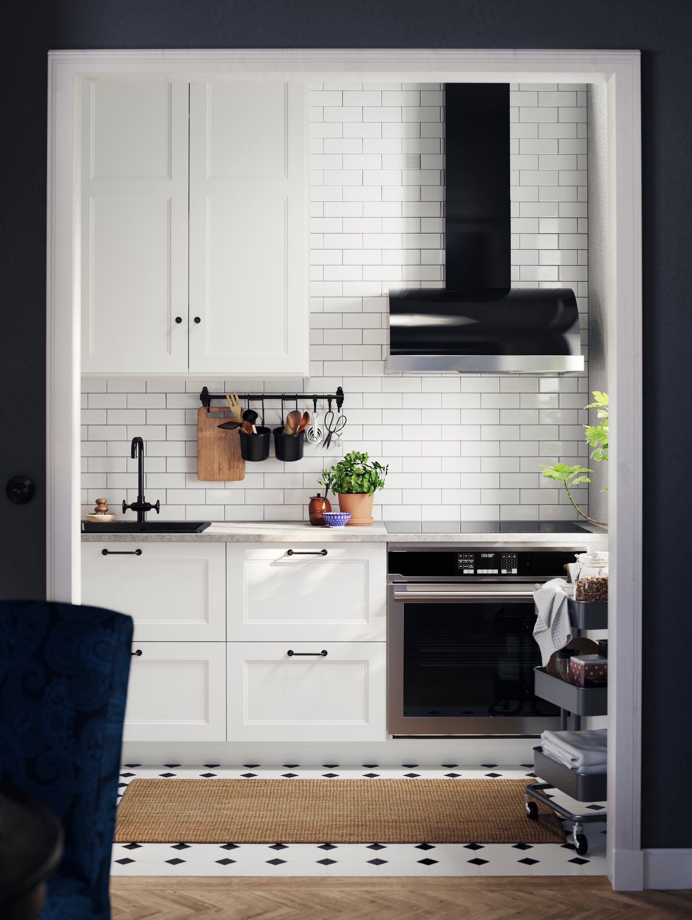 AXSTAD white kitchen fronts with black handles, a white tiled wall, and open shelving and a black extractor hood.